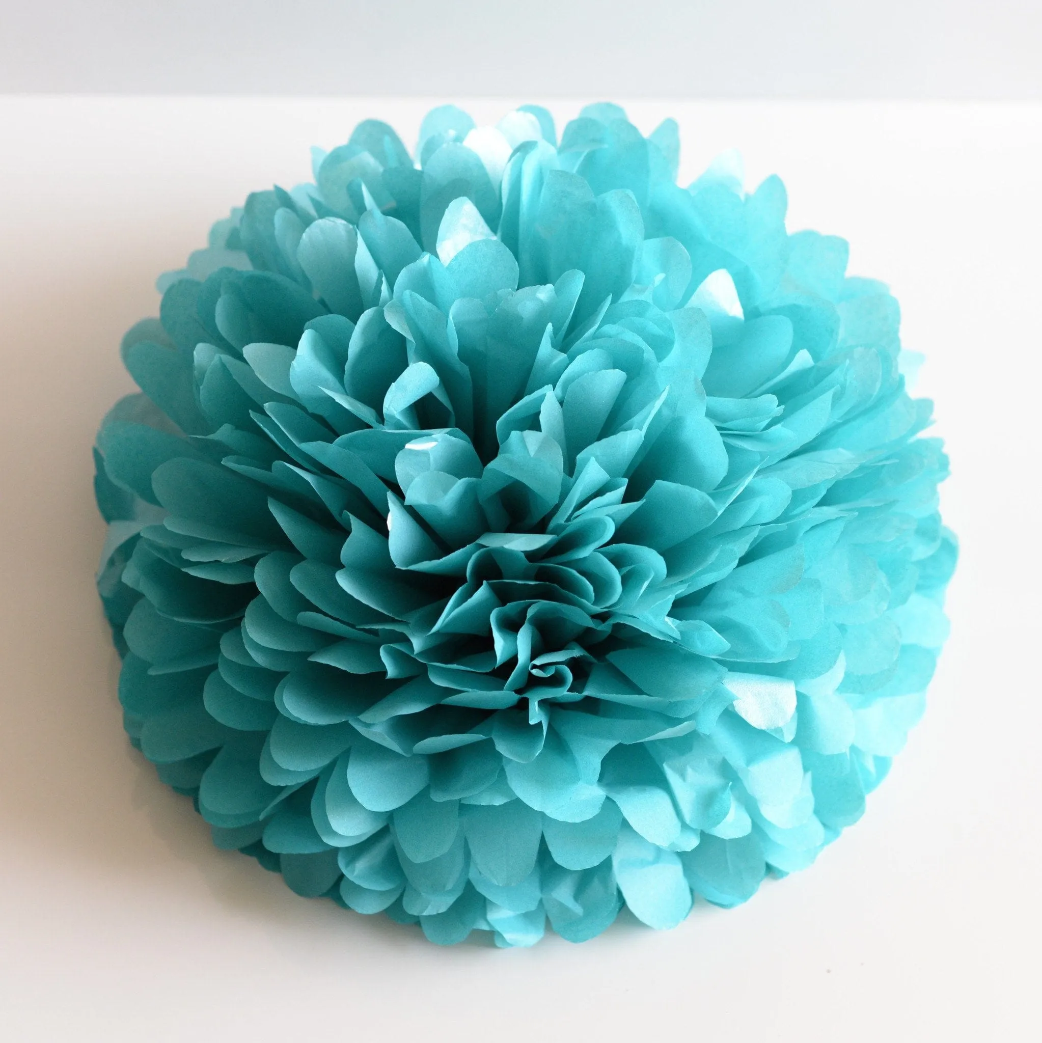 Shimmery turquoise paper pom poms